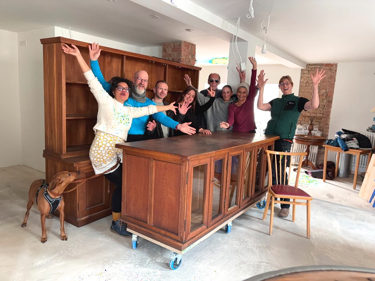 Das Team des Kulturhaus am Kreisel: sieben Menschen mit offenen Armen hinter der Theke